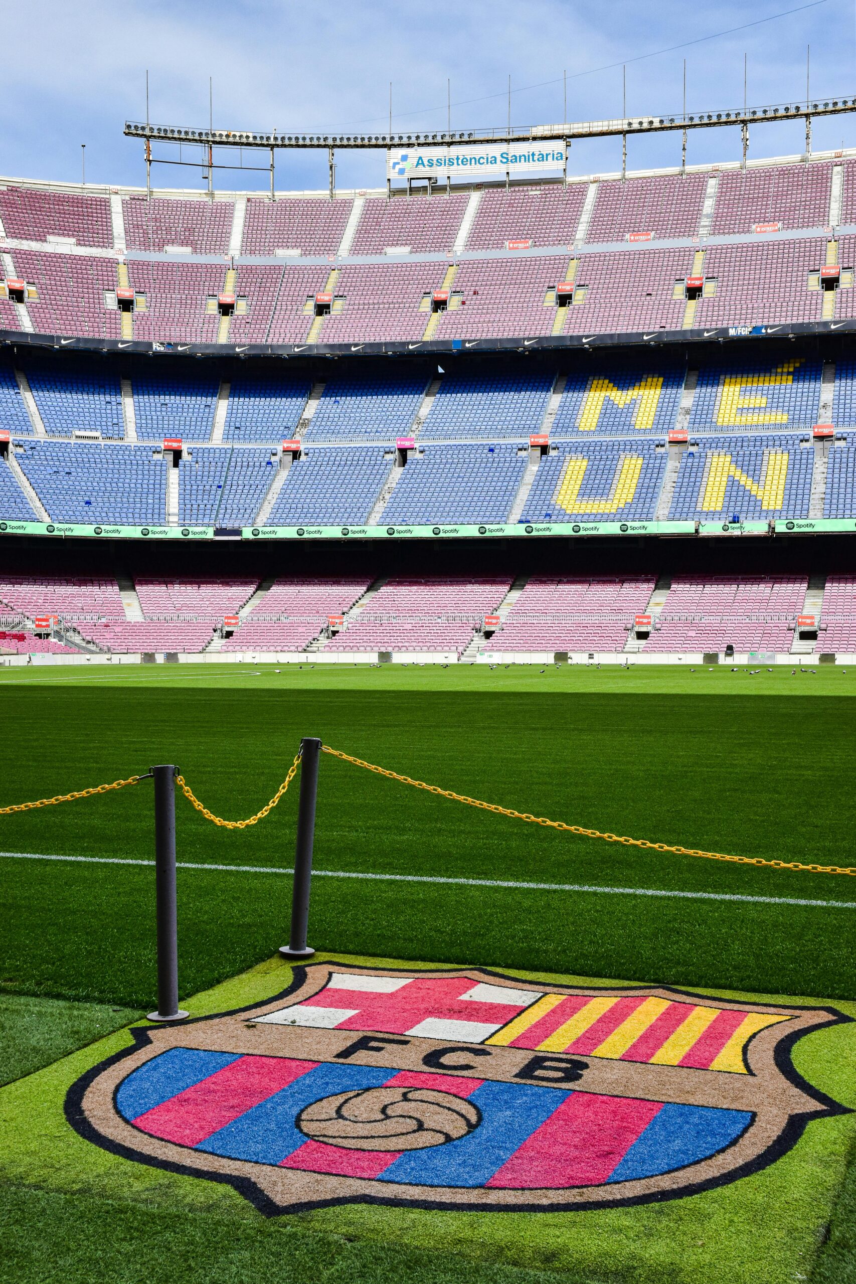 A clear daytime view of Camp Nou Stadium in Barcelona with iconic FCB logo on the field.